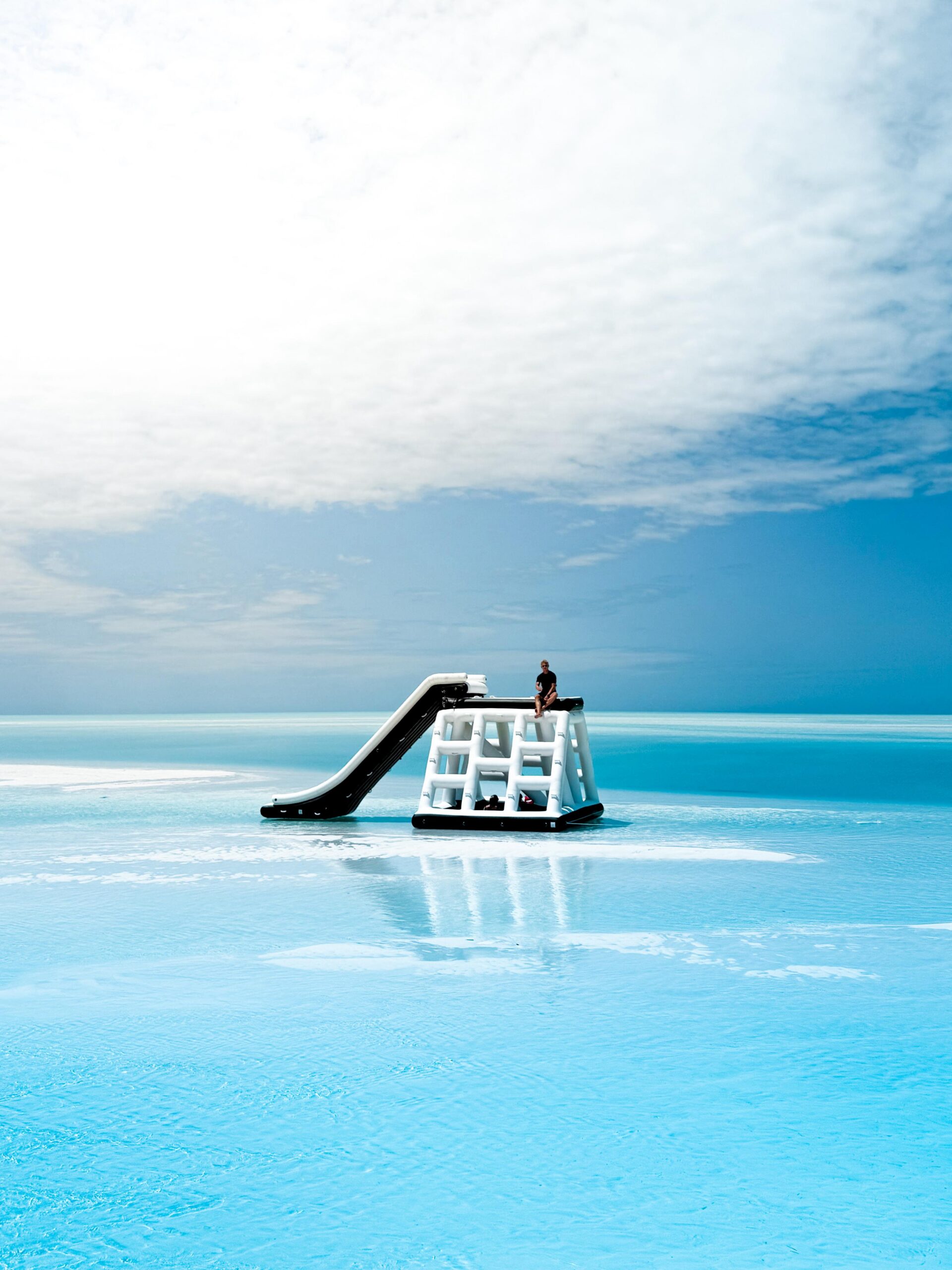 Inflatable water slide on turquoise ocean water