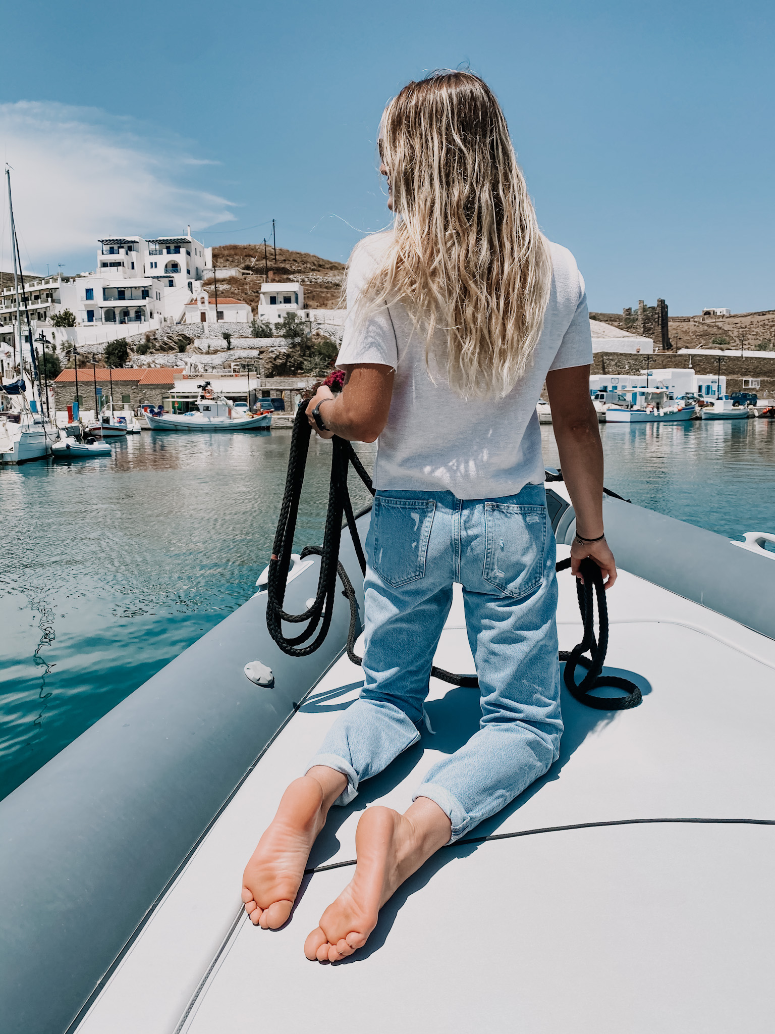 Woman relaxing on a yacht deck chair by the water